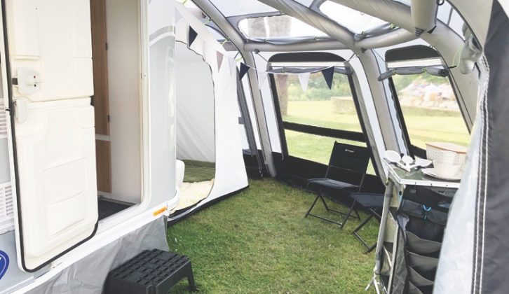 A tailored air awning wraps around the van