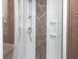 Shower cubicle has a large LED light and two useful shelves