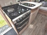 The kitchen is well equipped and comes with a dual-fuel hob and a microwave