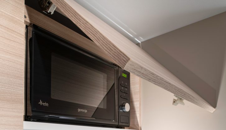 A microwave is fitted for cooking convenience