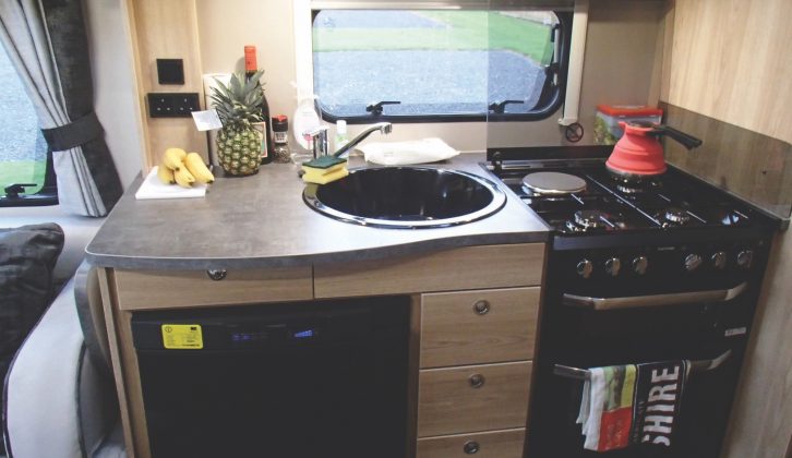 The well specified kitchen has a Thetford hob, grill and oven combo, and Dometic fridge located below the work surface