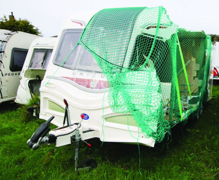 A damaged caravan with half of the exterior ripped off