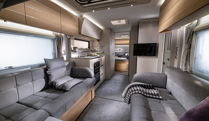 The interior of the Adria Adora Tiber, with the lounge and kitchen area well-lit thanks to daylight