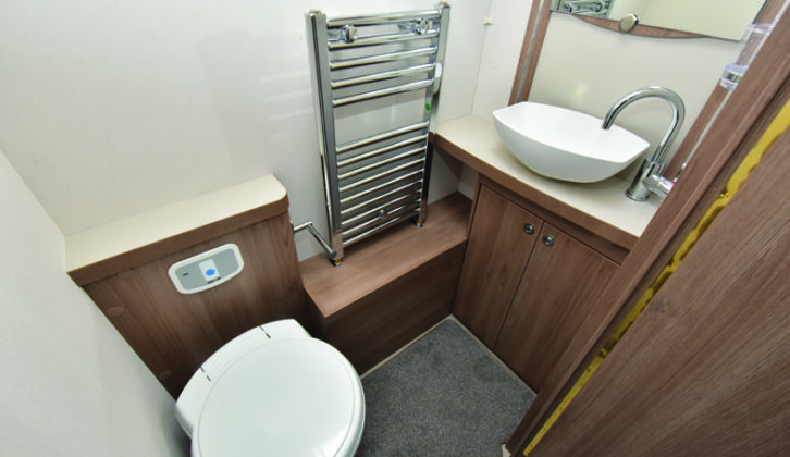 Midships washroom straddles the interior, with the toilet and handbasin on one side, and the circular shower cubicle with Eco showered just opposite