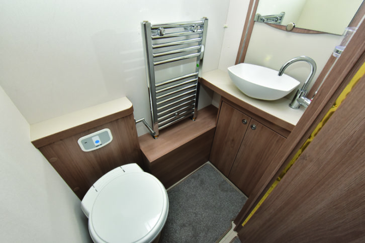Midships washroom straddles the interior, with the toilet and handbasin on one side, and the circular shower cubicle with Eco showered just opposite