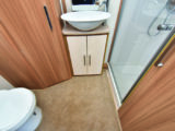 Rear washroom has ample floor space and good storage. Shower cubicle is domestic in style and fully lined