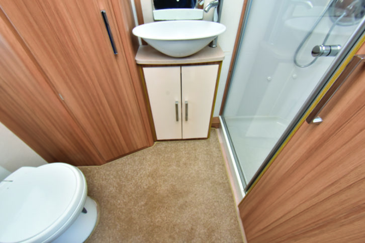 Rear washroom has ample floor space and good storage. Shower cubicle is domestic in style and fully lined