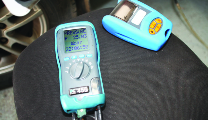 Using a meter to test the gas pressure. This device prints out a confirmation 'receipt' of the results