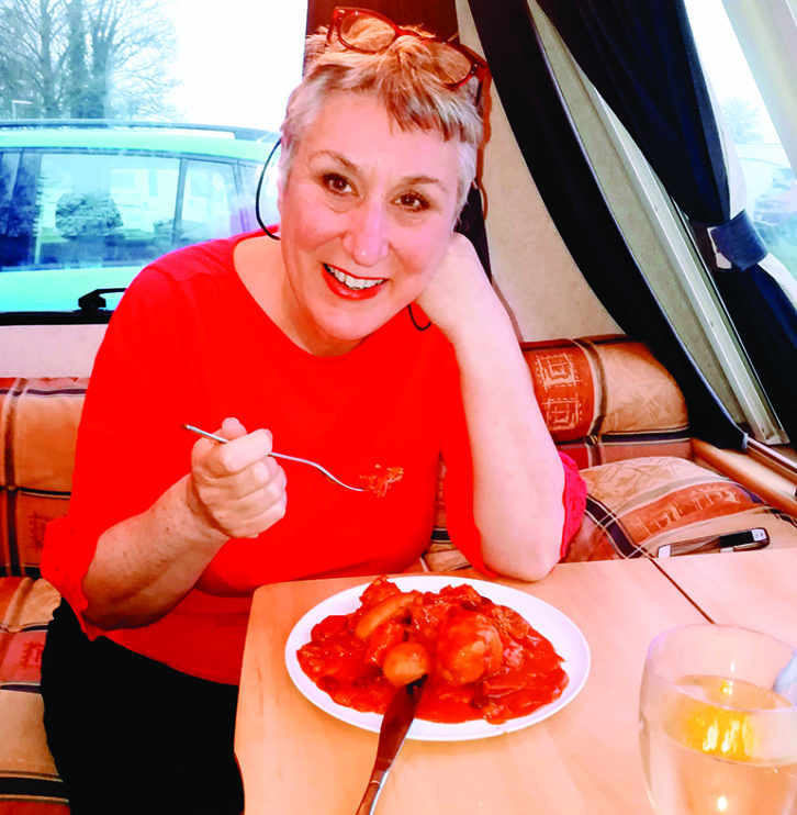 Caravan cooking is fun - especially with a glass of wine for the cook!