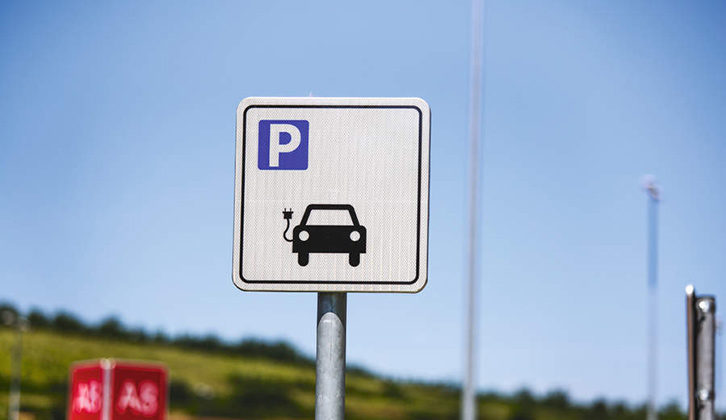 EV charging symbol on a signpost