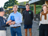 Daniel Holder and his son George receiving the glass vase for their green efforts at The Quiet Site