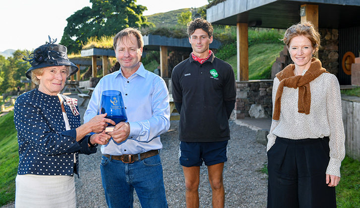 Daniel Holder and his son George receiving the glass vase for their green efforts at The Quiet Site
