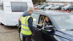 A woman in a tow car talking to an instructor