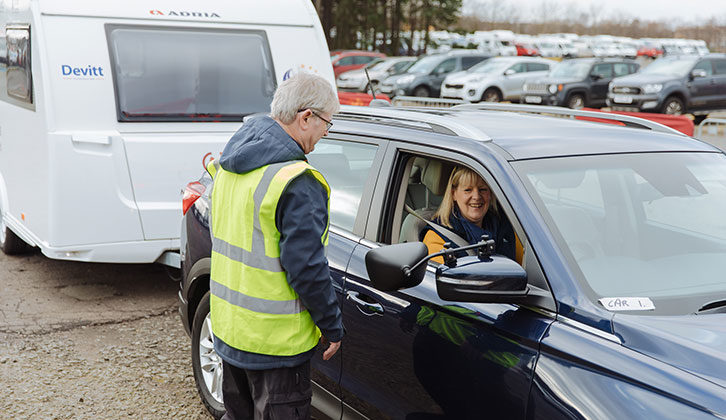 A woman in a tow car talking to an instructor