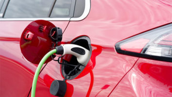 A red electric vehicle being charged