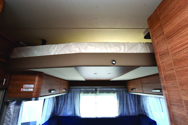 Drop-down double bed, a novel feature in a caravan, is powered by the 12V system