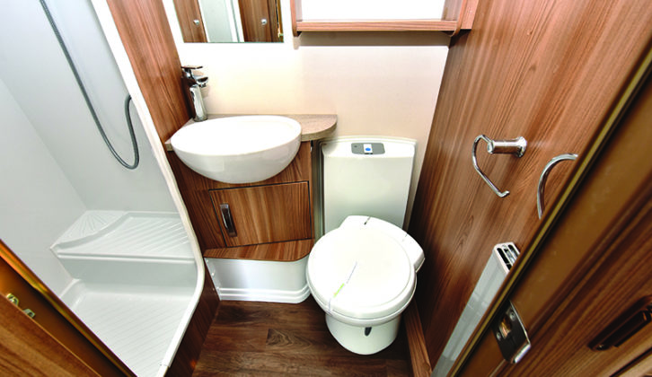 Central washroom has separate shower cubicle, deep basin and a radiator