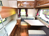 At the rear, there's a side dinette and fixed bunk beds