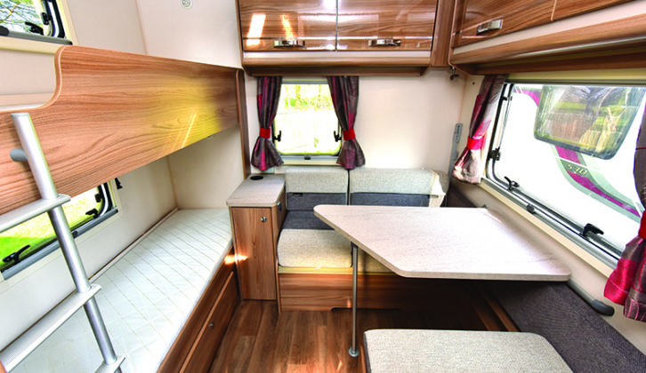 At the rear, there's a side dinette and fixed bunk beds