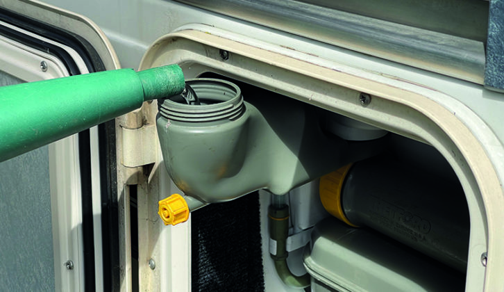 Replenishing the flush tank on a Thetford toilet