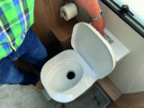 Drain a Dometic flush tank by pressing the button until it is empty