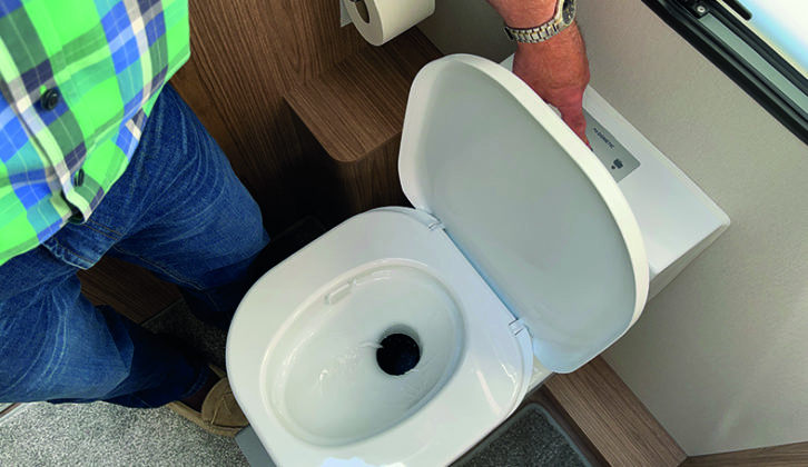 Drain a Dometic flush tank by pressing the button until it is empty