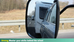 Towing mirrors showing the image of a caravan on a motorway