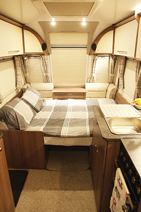 A bed made up in a caravan