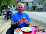 Nigel tucks into a bacon sandwich at High Nelly's Café