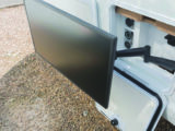Exterior TV bracket mounted inside an external locker, for use in the awning