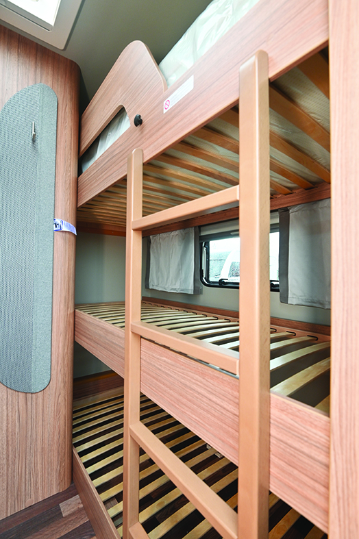 Triple bunk beds are solidly built, but only the middle one benefits from the window