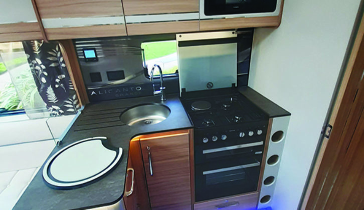 Well-appointed kitchen includes a turntable-free microwave and dual-fuel hob