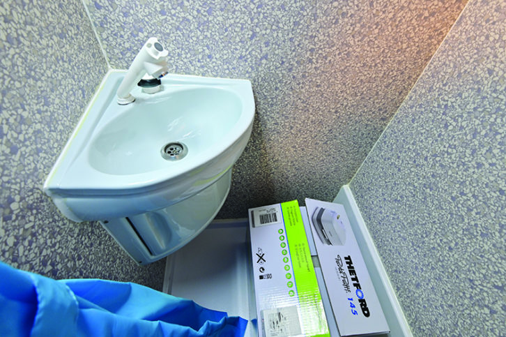 Basic washroom provides handbasin, small cupboard and Thetford Porta Potti