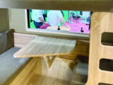 Rear dinette has a cutaway table to aid access to the pull-down bunk bed overhead