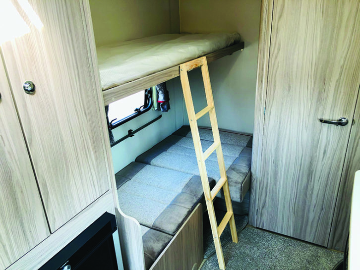 The two comfortable bunks made up in the dinette each have their own reading light