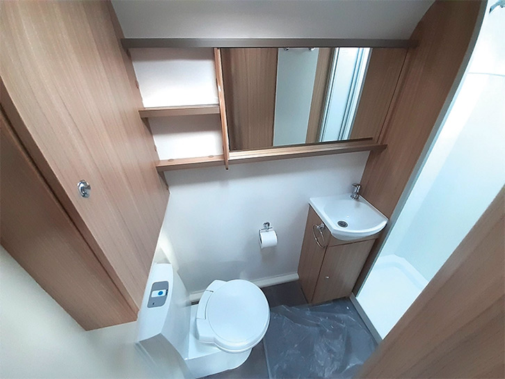 A big mirror creates a well-lit bathroom