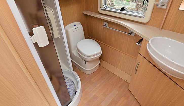 Rear washroom provides electric-flush toilet and circular shower cubicle