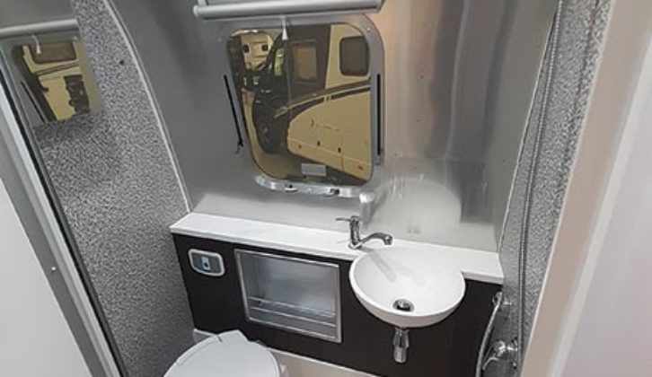 Airplane-style washroom provides excellent headroom and a sizeable handbasin