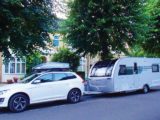 A caravan and tow car parked on a road