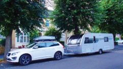 A caravan and tow car parked on a road