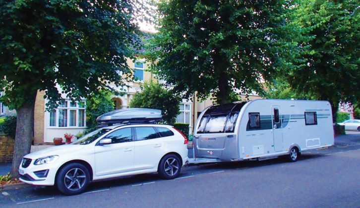 A caravan and tow car parked on a road