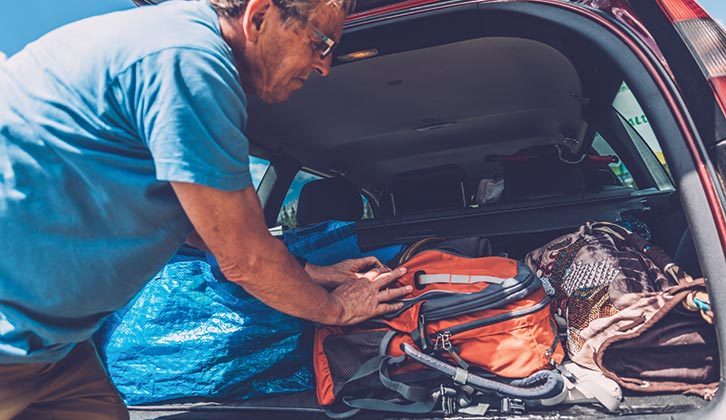 Baggage being fitted into a boot