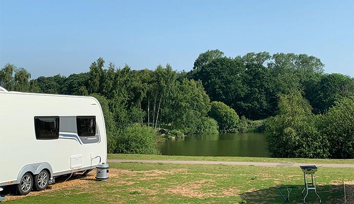 A caravan pitched by the water