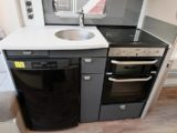 Side kitchen is well equipped and provides plenty of work surface