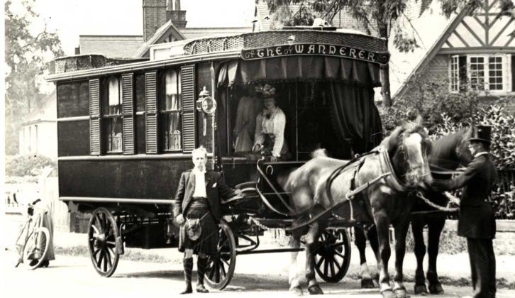 Man stands by horse drawn first ever caravan