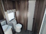 Spacious washroom with toilet in corner