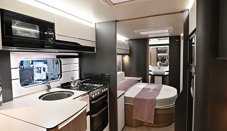 Interior shot of caravan showing kitchen and bed