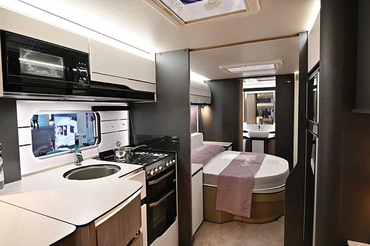 Interior shot of caravan showing kitchen and bed
