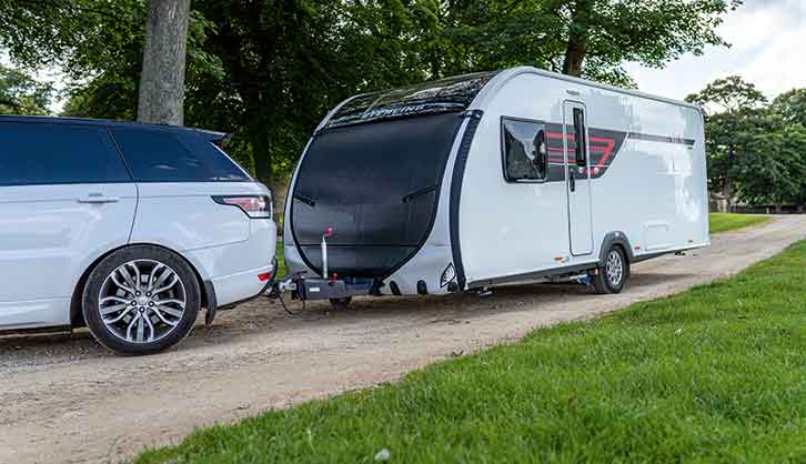 Car towing covered caravan