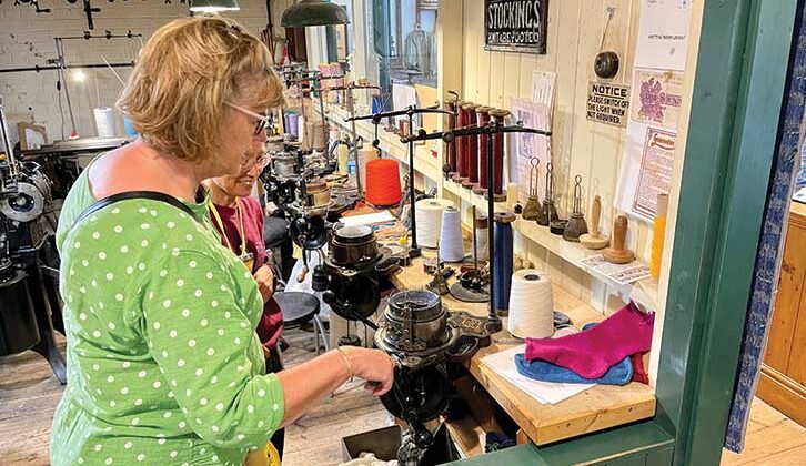 Woman at sock knitting machine